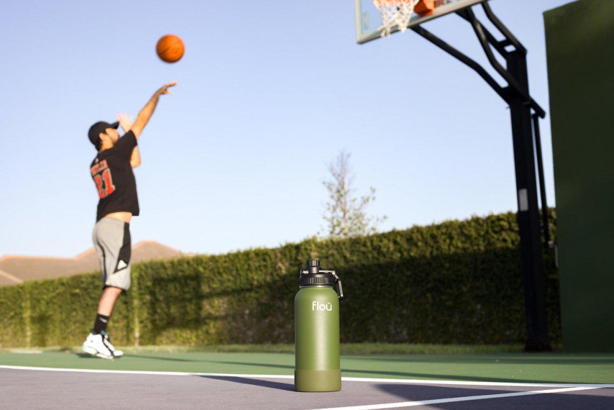 Man playing basketball next to an insulated water bottle.