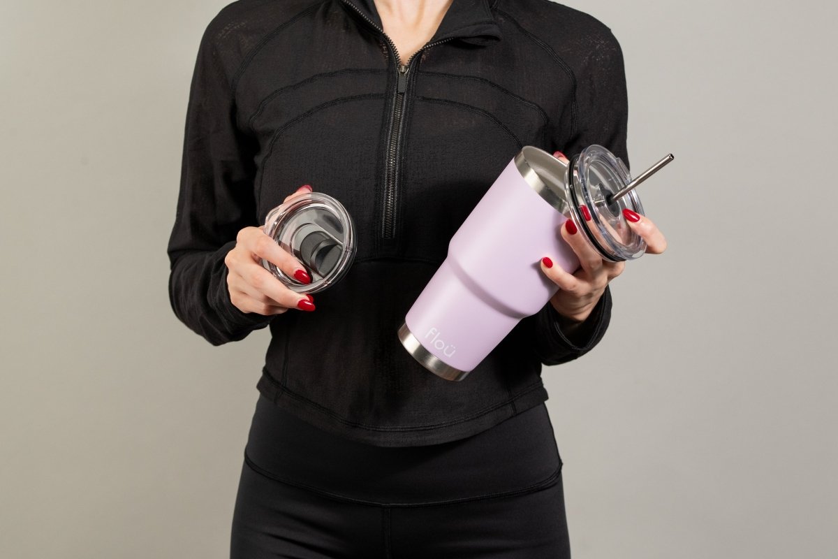 Women holding a purple tumbler with two lids